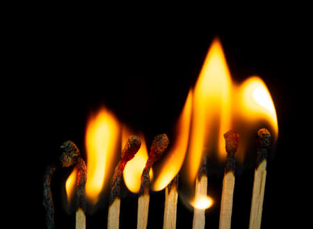 Group of red match burning isolated on black background. Row Burning In Chain Reaction