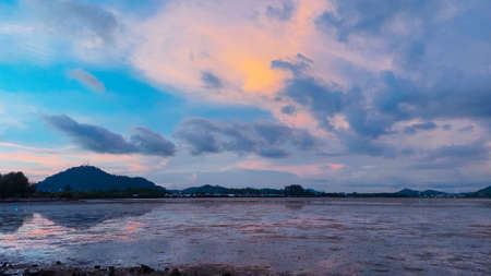twilight time sunset at park beach with low tide, twilight sky reflex on low tide beach. Sapanhin Phuket Thailand May 15,2021.の写真素材
