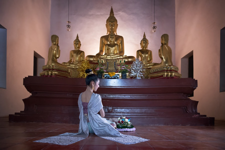 A woman in thai dress at the old templeの写真素材