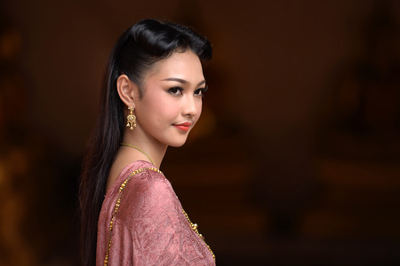 Asia woman in Thai dress traditional: Noppamas Queen Contest in Loy kratong tradition at Wat Phutthaisawan (Phutthaisawan temple), Ayutthaya province, Thailandの写真素材