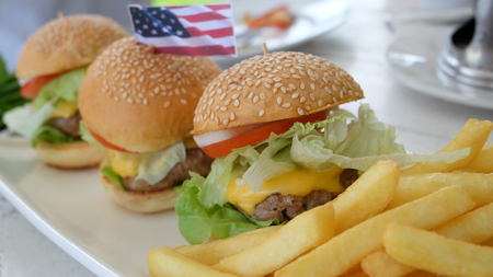 Big hamburger, French fries and vegetablesの写真素材