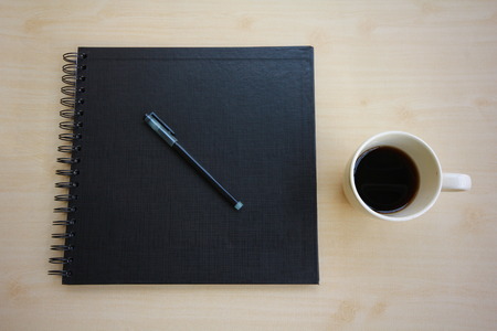 Notebooks, pens, coffee on the table