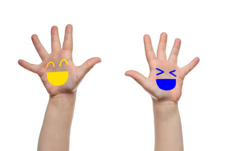 Children's hands with joyful faces painted on themの写真素材