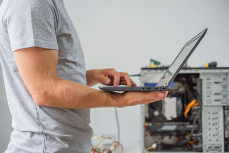 Man holding laptop to diagnose problem