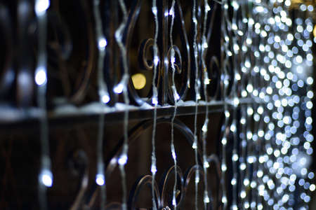 Glowing white garland lamps glow in the darkの写真素材