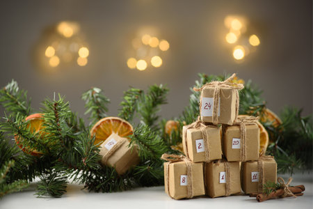 Fir branch decorated with dried oranges and advent calendar gifts. Preparing for the new year and...