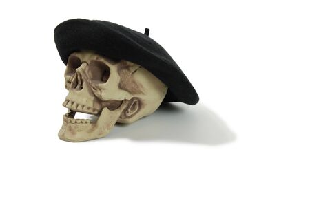 Black Beret that wears tight to the head on a skull with eye sockets and teethの写真素材
