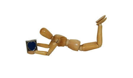 Holding a heart shaped silver frame and gazing at itの写真素材