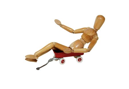 Little red wagon brings back memories of childhood to wooden model representing a personの写真素材