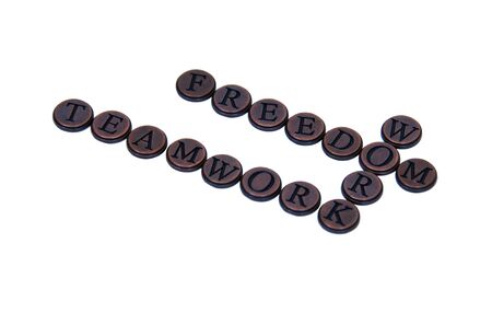 Little brass letters similar to old manual typewriter keys that spell out ideas such as teamworkの写真素材