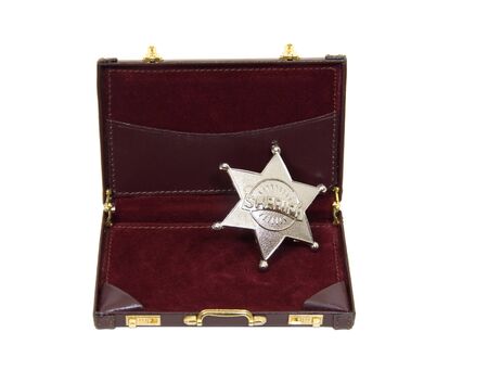 Silver five pointed star used as a sherff badge sitting in a briefcase - includedの写真素材