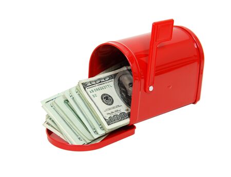 Red metal mailbox with signal flag full of large bills of moneyの写真素材