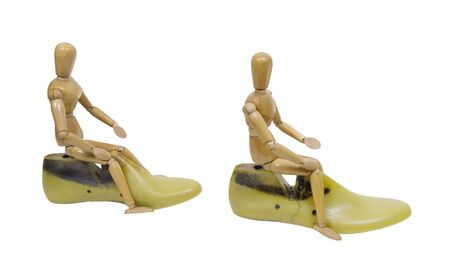 Wooden models riding yellow plastic shoe molds used to make high fashion shoes