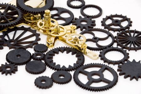 Various black and gold gears with interlinking teeth and cogs
