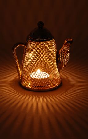 Mesh tea pot decoration candle holder splashing diamond shapes along the floor の写真素材