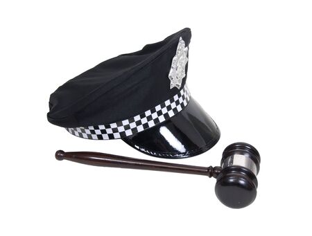 Law and order shown by a police hat with badge and a wooden gavel - path includedの写真素材