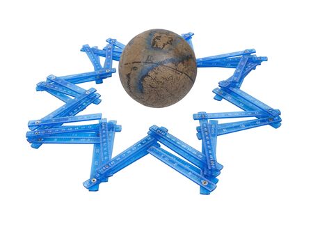 Measuring world stars shown by an old world globe with folding rulers making the shape of a starの写真素材
