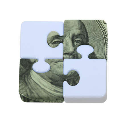 The puzzle of money shown by contrasting puzzle pieces interlocked with money portionsの写真素材