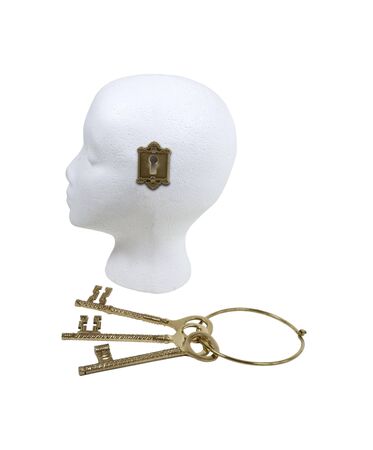 Unlocking creativity shown by a set of ornate keys and a keyhole on a model headの写真素材