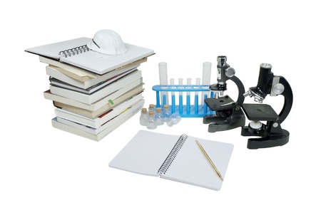 Laboratory research shown by microscopes and test tubes with a stack of books and note paper - path includedの写真素材