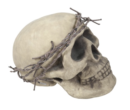 Skull with eye sockets and teeth wearing a crown made of barbed wire thorns - path includedの写真素材