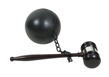 Facing legal issues shown by a wooden gavel attached to a ball and chain - path includedの写真素材