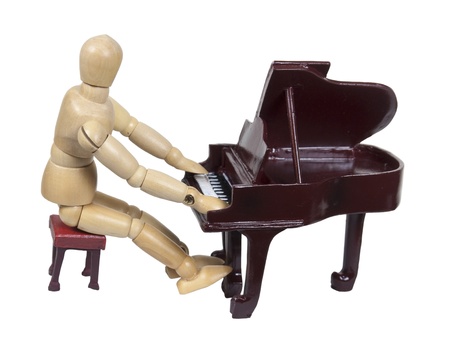 Sitting on a bench and playing a traditional wooden piano - path includedの写真素材