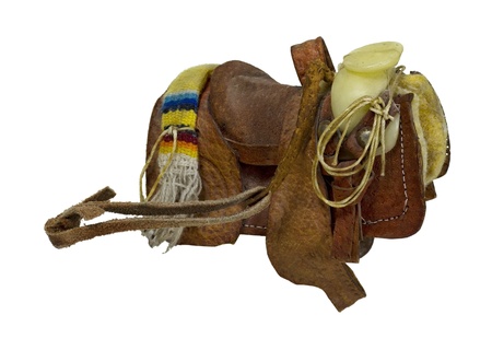 Old western saddle made of heavy leather for riding domestic horses - path includedの写真素材
