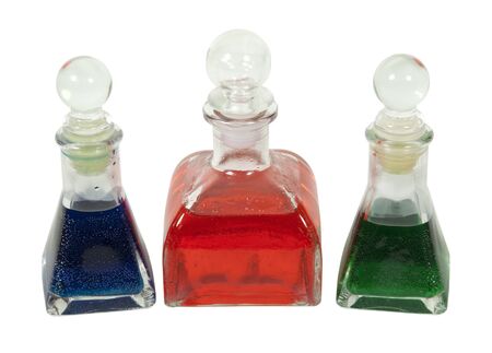 Glass bottles filled with colorful liquid with with glass stoppers の写真素材