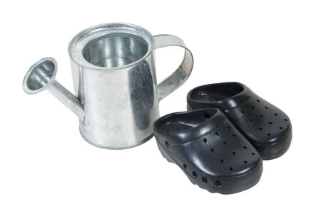 Small metal watering can and rubber gardening shoes - path includedの写真素材