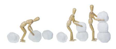 The process of amMaking a snowman by piling balls of snow together - path includedの写真素材