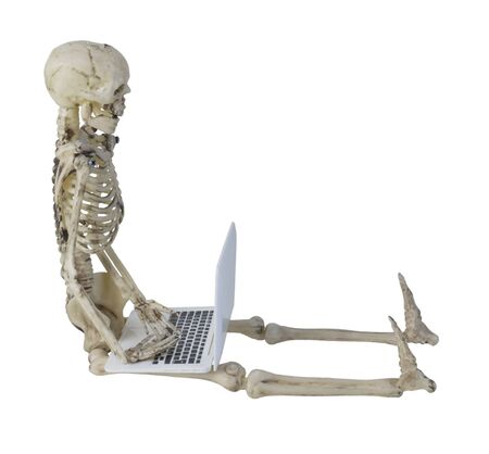 Skeleton using a Laptop computer used for data management, storage and convenience - path includedの写真素材