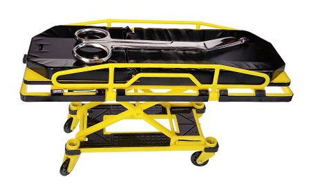 Curved dressing scissors for help in removing medical gauze on a hospital gurneyの写真素材