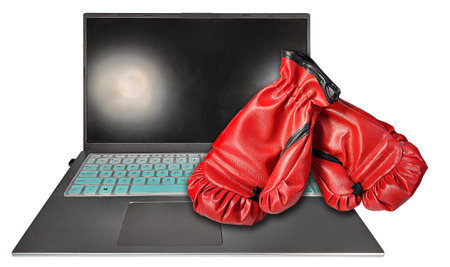 Laptop computer holds lots of computing power with boxing glovesの写真素材