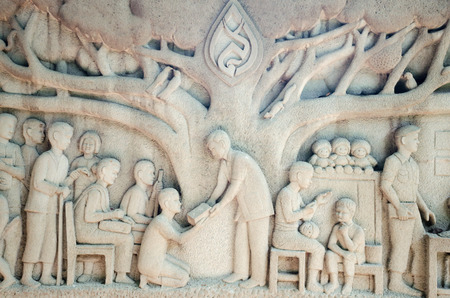 Intricate Thai carving mural -  Thai King activity help peopleの写真素材