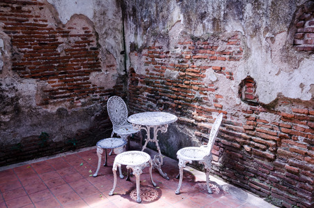 Garden furniture set with old brick wallの写真素材
