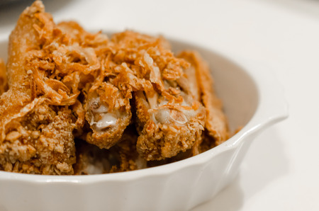 fried chicken with garlic on white bowl closeupの写真素材