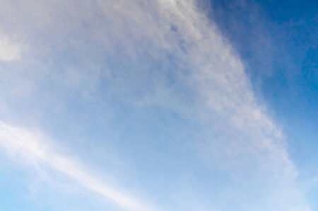 beautiful feather-like cloud in blue skyの写真素材