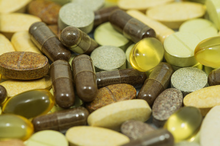 Drugs and food supplements pills and capsules macro backgroundの写真素材