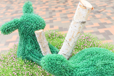 Topiary tree  in rabbit and turtle shape decoration in the parkの写真素材