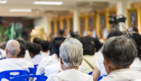 Bangkok , Thailand - September 21, 2014:  Unidentified Thai Buddhist people sit around indoor  for listen to Dhamma of Buddhism from monks at Wat Rajadhivas Temple in Dusit Area ,  Bangkok Thailandの写真素材