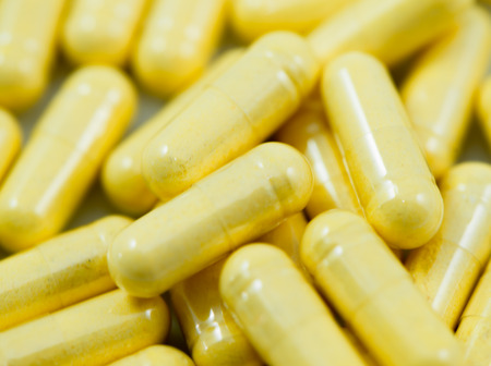 Yellow capsules background macro contain Co-enzyme Q10 macro  closeup background