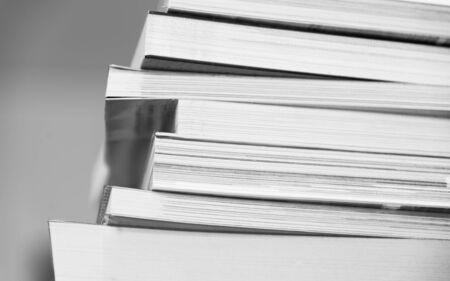 Stack of multiple sizes of  books  closeup black and white vintage retroの写真素材