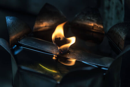 Flame of Oil Lamp in the darkness closeupの写真素材