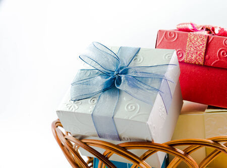 Gift boxes on basket isolated on white background focus on blueの写真素材
