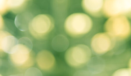 Defocused of yellow  and green glowinglight blured bokeh  abstract backgroundの写真素材