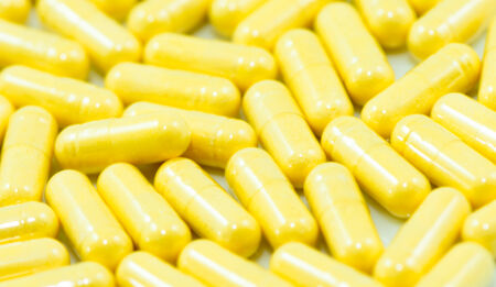 Yellow drug capsules of Co-enzyme Q10 macro closeup backgroundの写真素材