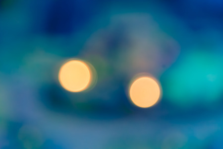 blur bokeh of two light with aqua green abstract backgroundの写真素材