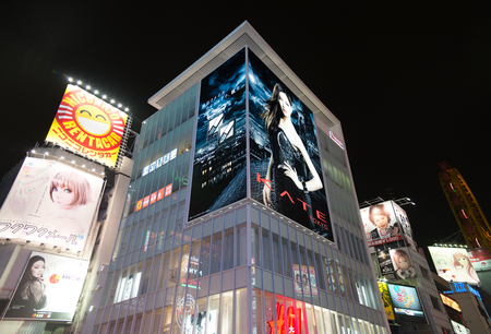 Osaka, Japan - February 2 , 2015 : Urban scene at night focus on Gulico Building  , the most famous landmark in Osaka , Japanのeditorial素材
