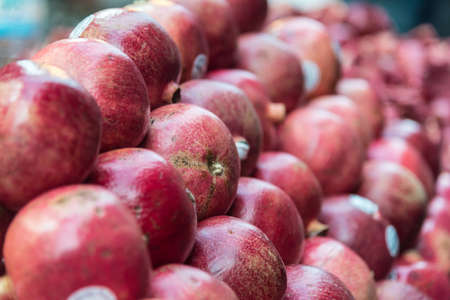 Red pomegranate fruit closeup in the marketの写真素材